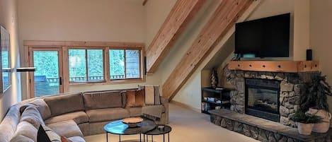 Living room area with gas fireplace and smart TV.