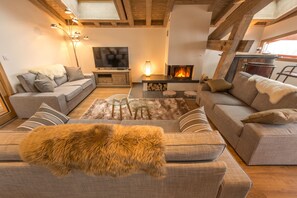 Chalet 75 cosy living area with log fire and smart TV.