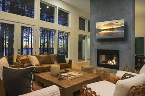 Living Room: Sunset views and sleek decor invite relaxation by the fireplace or on the plush sofa!