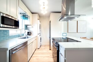Fully equipped kitchen with coffee maker,  kettle, toaster, blender, rice cooker