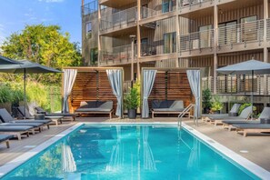 Pool with cabanas and long chairs