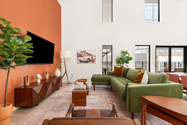 Step into our vibrant bohemian-inspired living space, complete with soaring ceilings that add an extra touch of grandeur to your stay