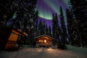 The cabin with you Aurora in the background