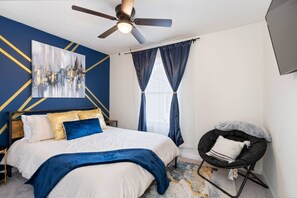 3rd bedroom featuring queen bed and tv