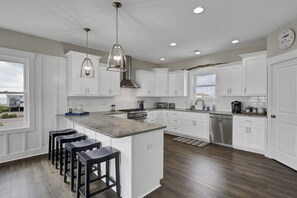 Bar seating and oversized kitchen.  All Thermador Professional appliances