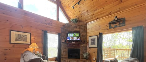 At Bearfoot Lodge the living room boats a gas fireplace, sleeper sofa, and loveseat, and Roku TV for streaming!