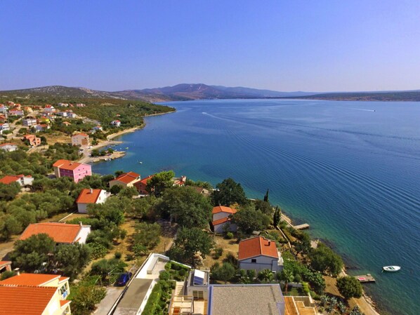 Water, Sky, Property, Building, Azure, Plant, Coastal And Oceanic Landforms, House, Natural Landscape, Tree