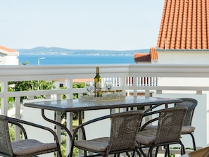 Table, Furniture, Sky, Water, Chair, Outdoor Table, Outdoor Furniture, Building, Tableware, Wood