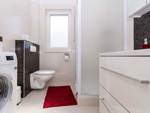 Plumbing Fixture, Laundry Room, Toilet Seat, Cabinetry, Building, Toilet, Flooring, Bathroom, Floor