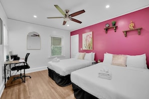 Our room with two full-size beds, a desk, and a computer is ideal for work and play, ensuring you have everything you need for a productive stay.