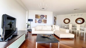 The living room beckons with a sprawling sofa, strategically positioned to offer an unobstructed southern view of the ocean. Immerse yourself in comfort and stunning vistas. #relaxingsofa #modern #livingroom #dining room