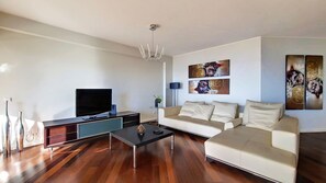 Chic living room adorned with vibrant paintings, adding a touch of modern elegance and personality. #decordetails