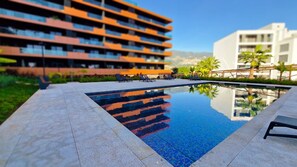 Dive into luxury at Roots Loft, where the lovely outdoor pool invites relaxation and leisure, creating a perfect oasis for your stay. #rootspool #community pool