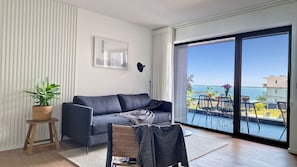 Savor indoor elegance with an incredible balcony view at Roots Loft—a seamless blend of comfort and breathtaking scenery awaits you. #balcony #oceanview #modern #sofabed