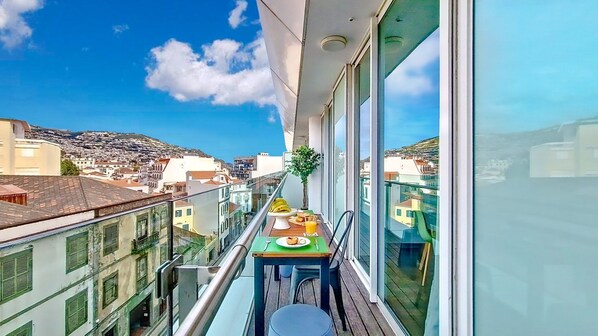 Experience Funchal's charm at Upscale 3 by Lovelystay: a stunning apartment with mountain-view balcony, prime location, free parking, and AC. Book now! #balcony #mountainview #privateparking