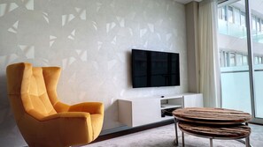 Close-up view of the stylish chair and TV in the living room, perfect for relaxation and entertainment. #details #modern #smartTV