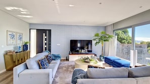 Inviting entrance living room exudes charm, offering a panoramic perspective that seamlessly combines elegance and warmth #sofas #bluesky #luxurydecor