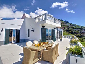The façade of this Funchal villa seamlessly marries traditional architectural elegance with contemporary design elements, inviting you to experience the best of both worlds.