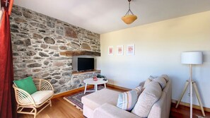 Inviting living room radiates warmth and comfort in every detail.
#stonewall #TV #sofa