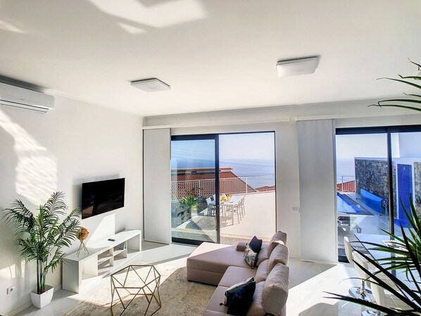 Spacious living room, ocean view backdrop, complete with the SmartTV- where entertainment meets tranquility #relaxingholidays #oceanview #sofa