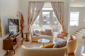 Living Room: Welcome to our haven of warmth and joy! Dive into the heart of relaxation in our cozy living room, where every corner invites laughter and cherished moments with loved ones. 