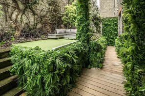 Exquisitely Designed Private Garden Oasis with Inviting Seating Area.