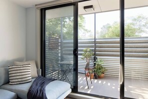 The living area opens to a private balcony, creating a lovely outdoor nook to sip your morning coffee.
