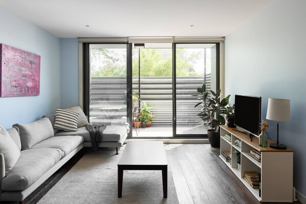 Settle into the inviting living area before stepping out to the balcony for a serene outdoor retreat.