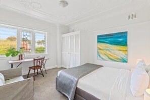 The first bedroom features a comfortable queen-sized bed and ample storage space.

