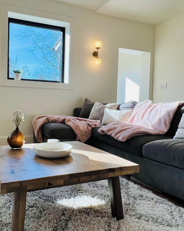 Bright and spacious living with vaulted ceilings and comfortable furniture. 