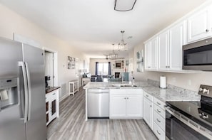 Open flow between kitchen, dining, and living areas