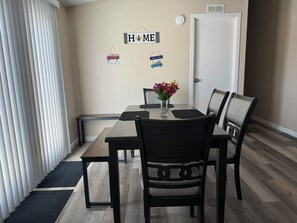 Spacious Dining Room and extra seating (benches), French doors to outside deck
