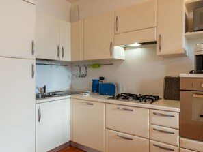 Cabinetry, Property, Countertop, Building, Kitchen Appliance, Kitchen, Kitchen Stove, Lighting, Interior Design, Drawer