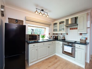 Cabinetry, Countertop, Kitchen Stove, Kitchen Appliance, Kitchen, Wood, Home Appliance, Interior Design, Flooring, Houseplant