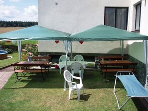 Furniture, Table, Building, Shade, Outdoor Furniture, Outdoor Table, House, Chair, Public Space, Sky