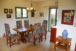 Dining room with Antique olive wood table Doors to the barbecue and patio