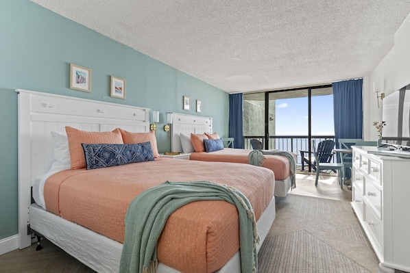 Indulge in Coastal Comfort: Two Luxurious Queen Beds with Pillow-Top Mattresses Await in our Oceanfront Studio Condo.