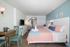 This inviting space features two plush beds, a charming dining nook, and a smart TV, all set in a beautifully designed coastal retreat. Relax in comfort and enjoy a perfect beach escape with t