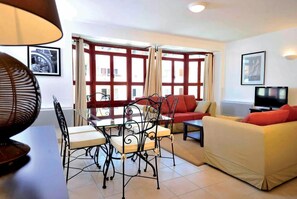 Spacious and airy living room with natural light and a cozy seating area.