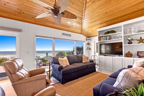 Large oceanfront living area with plenty of seating and a large-screen TV. Phenomenal view.