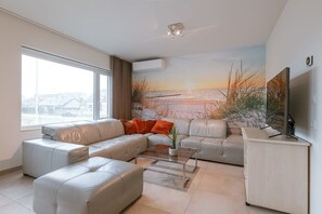 Big seating area with beautiful wall and television