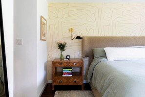 Relax in style with this cozy king-size bed and warm, inviting vibes.