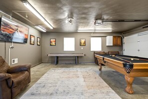 Enjoy the big game in the ultimate game room/man cave. Live cable TV, pool table, shuffle board, darts, and space to spread out. 