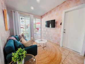 Living Room: Bright vibes with tropical decor, plush seating, and sliding doors to outdoor bliss!