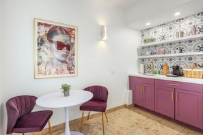Charming Kitchen Nook: Vibrant art and stylish touches create a delightful space for culinary adventures!

