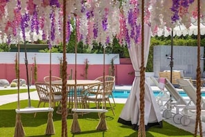 Vibrant swings and chic seating await by the sparkling pool—paradise is calling!