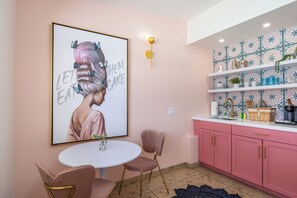 Charming Kitchen Nook: Vibrant art and stylish touches create a delightful space for culinary adventures!