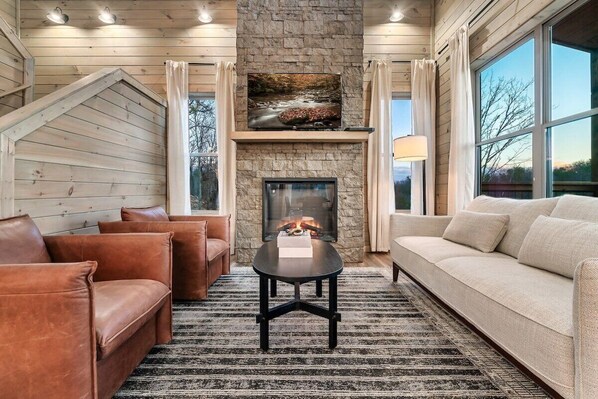 Enjoy stunning views and relax by the stone fireplace in this stylish retreat!