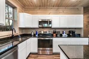 Sleek modern design with granite countertops invites culinary adventures in Gatlinburg!