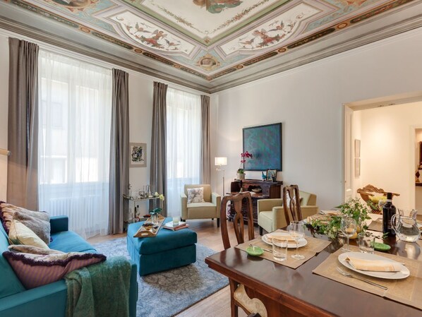 The living room is elegant and spacious, with a wonderful painted ceiling